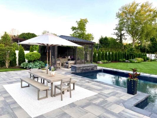 Outdoor seating area with table and seating area by a pool near Florence, KY