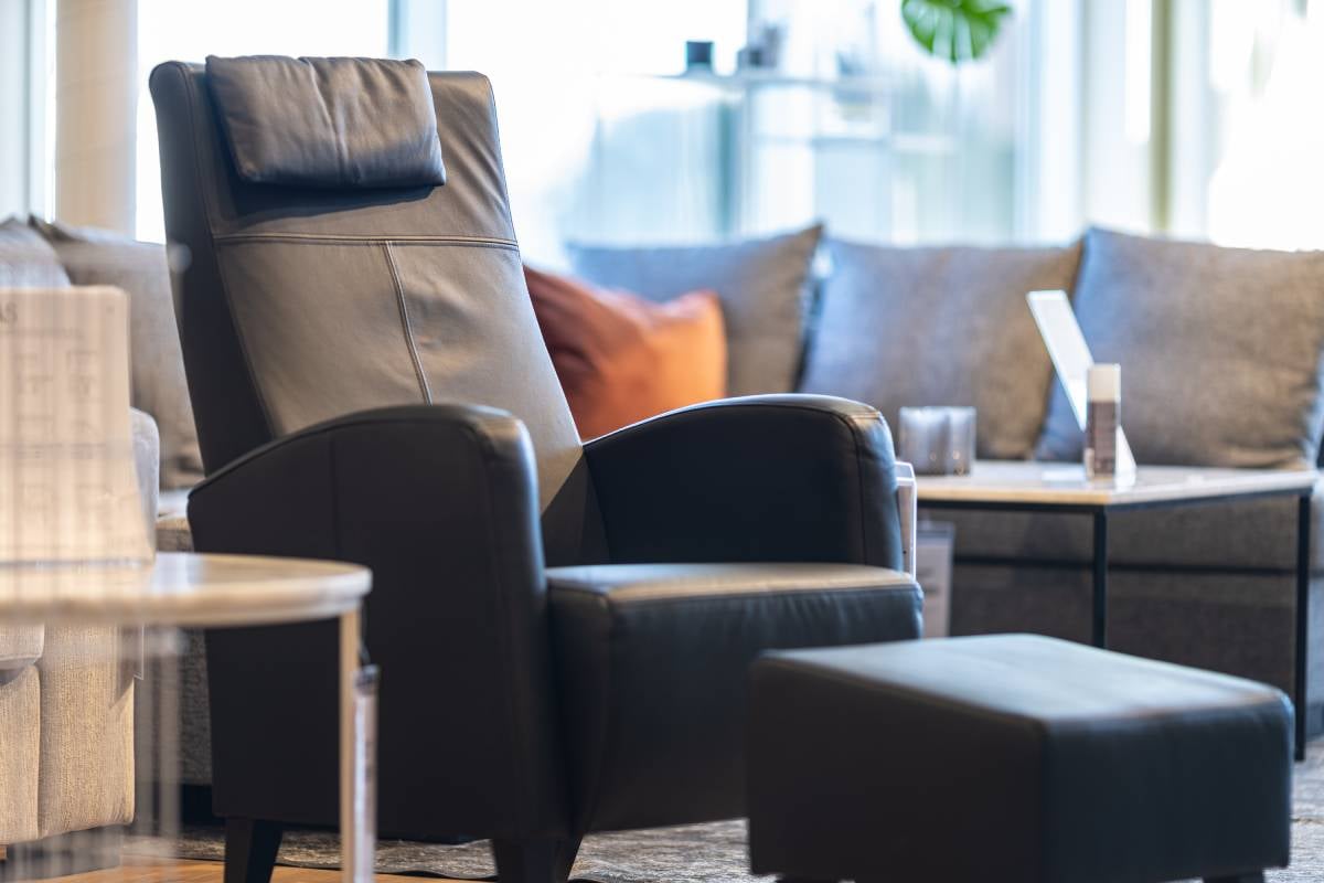 Black leather recliner with footrest in a modern living room near Florence, KY