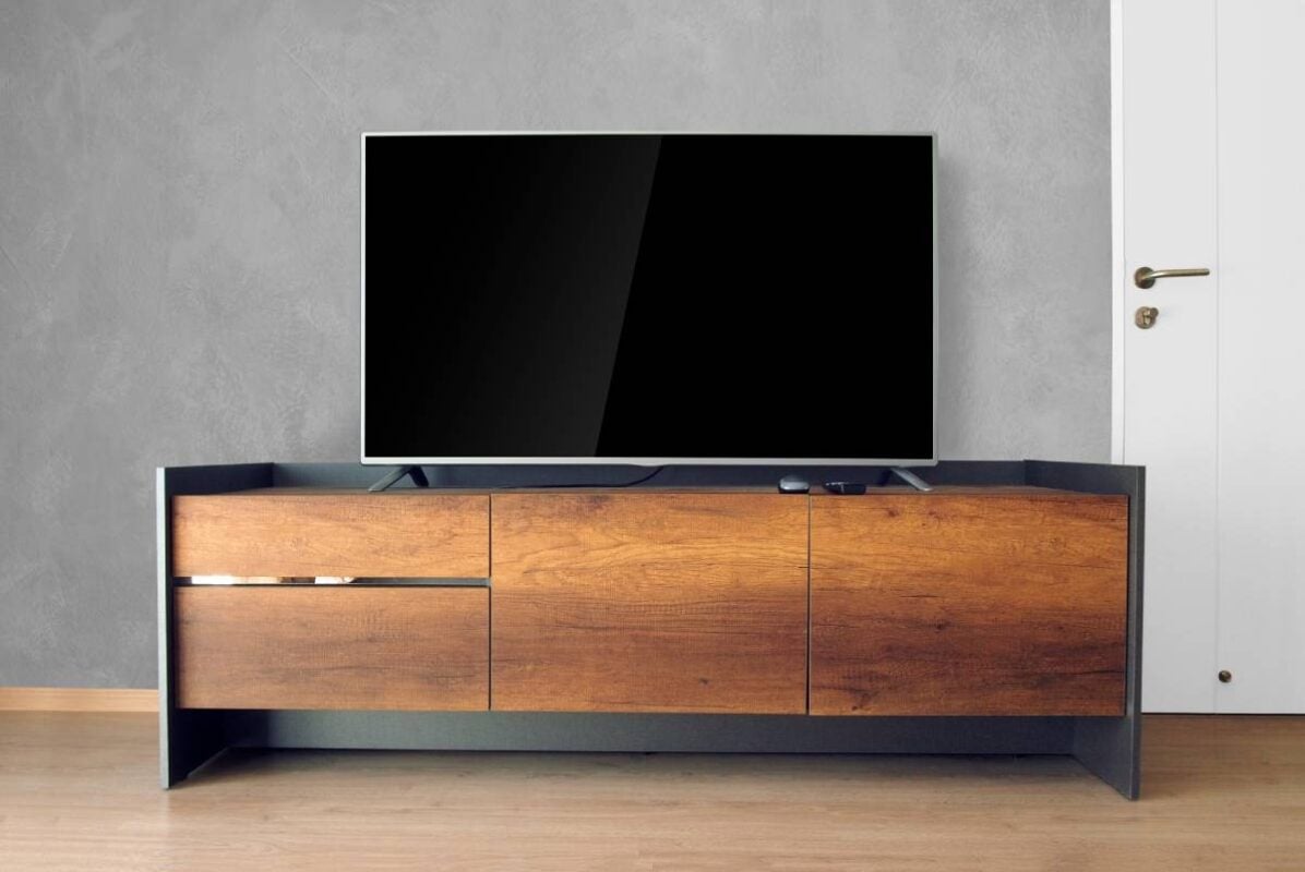 Wooden tv stand in a living room holding a flatscreen tv near Florence, KY