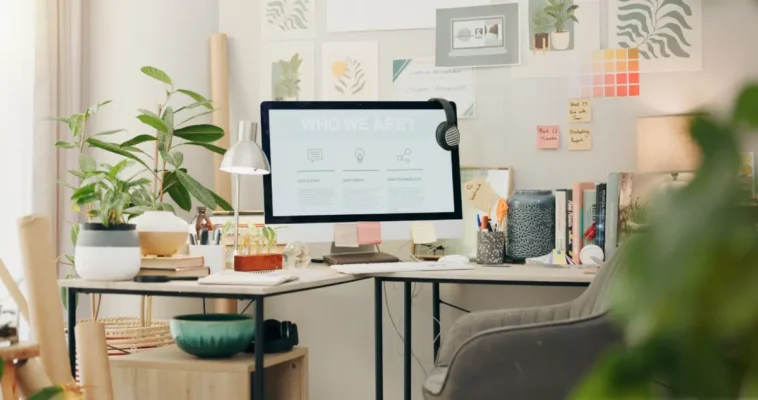 Modern home office with L-shaped desk, office chair, and storage.